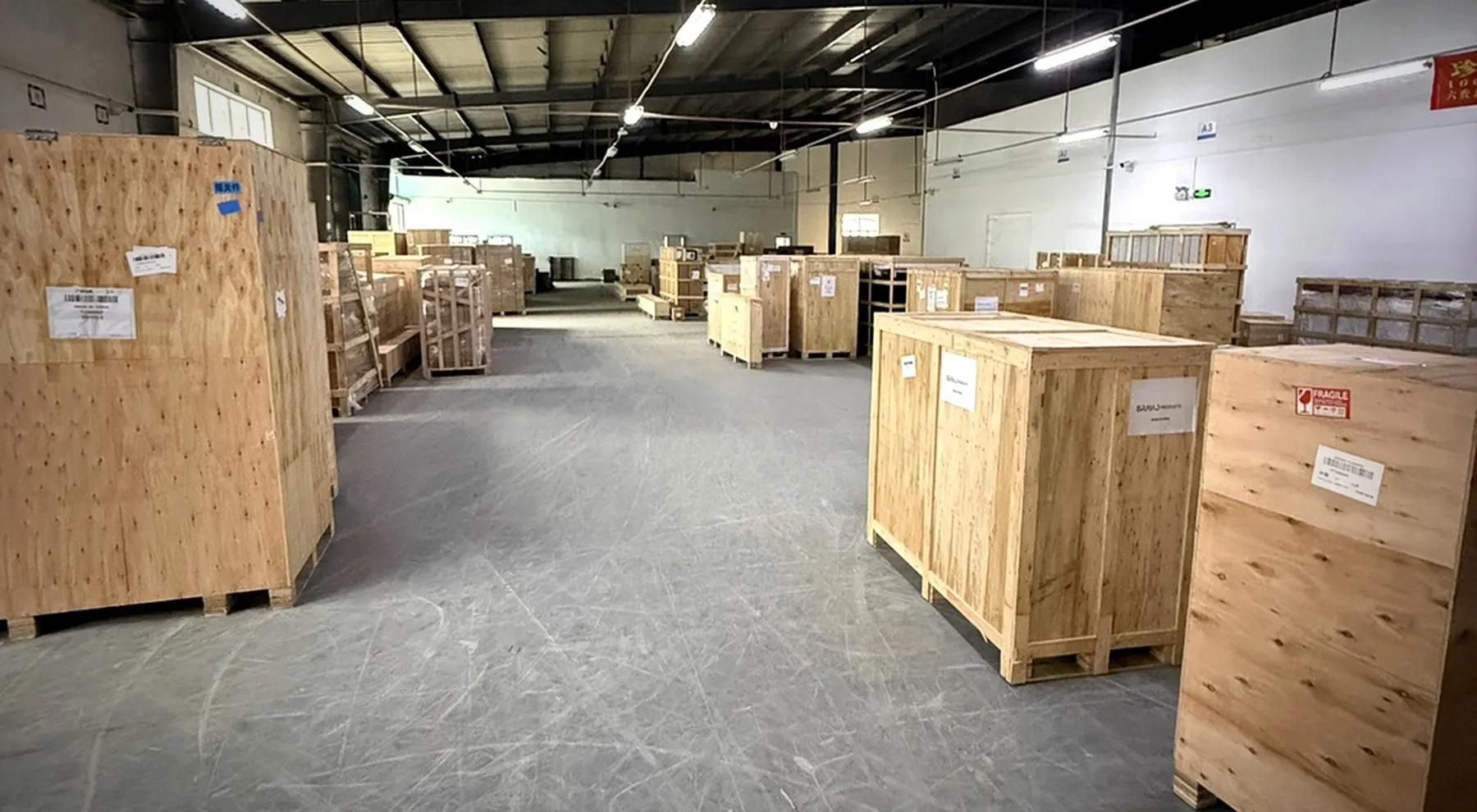 Wooden-crated bulky cargo stored inside the BuildCargo Logistics warehouse