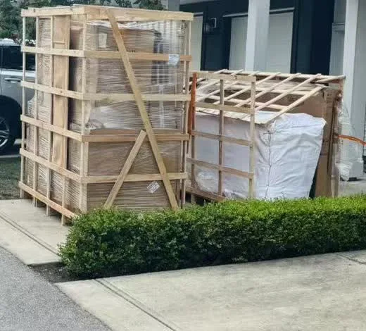 Export-crated household cargo at the completed Canadian residential delivery stage