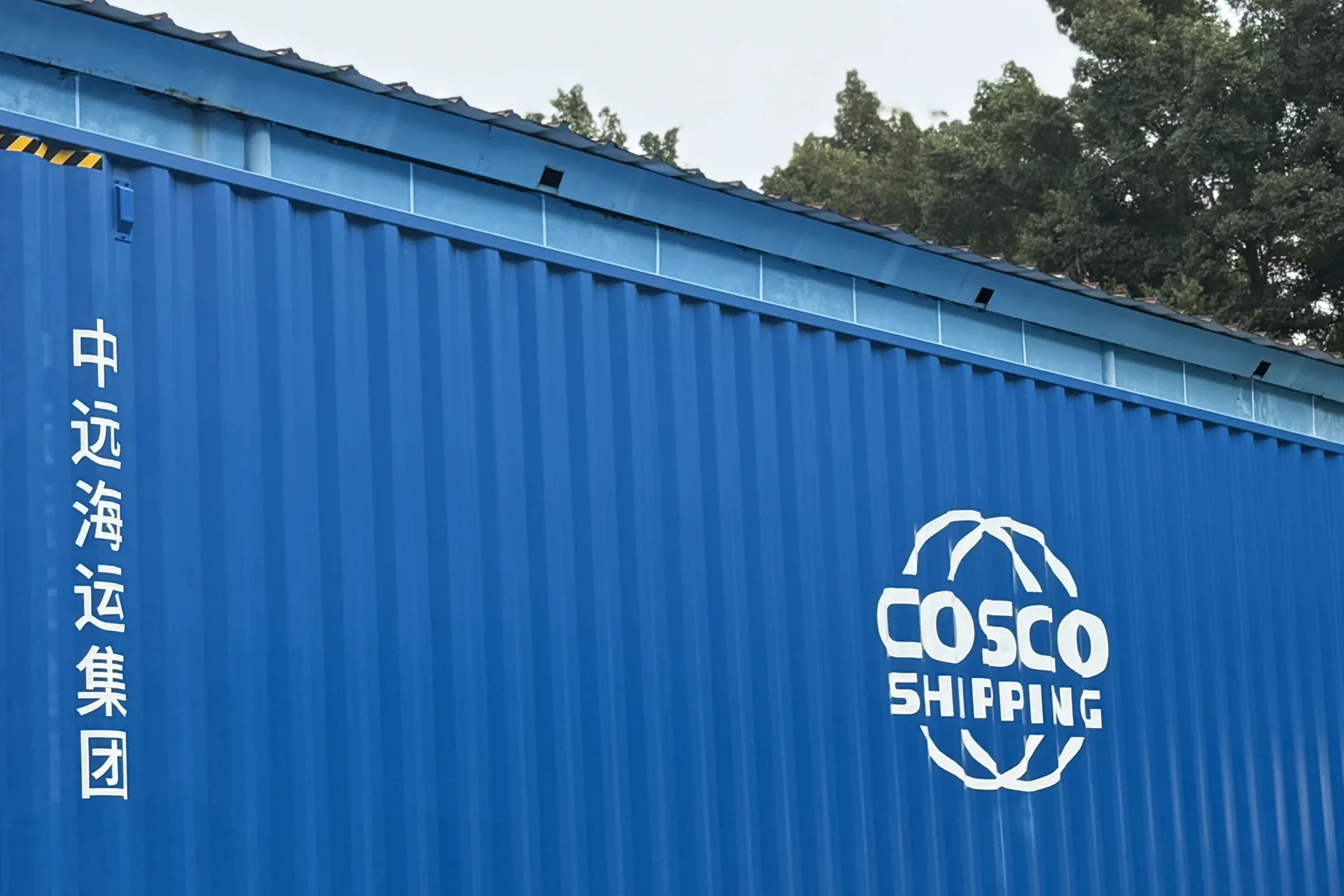 A sealed shipping container positioned at the warehouse before international dispatch